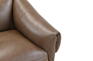 Close-up of a brown leather sofa seat on a white background