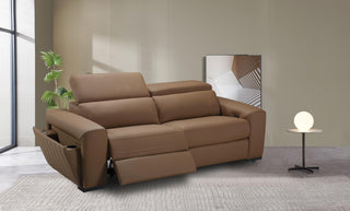 Brown leather sofa in a modern living room with a side table and plant.