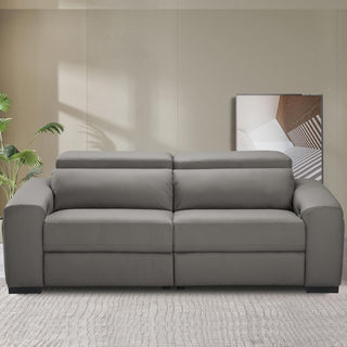 Gray sofa in a room with a plant and abstract painting on the wall.