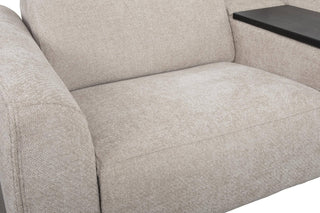 Close-up of a beige fabric sofa with a small table on a white background
