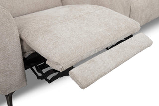 Beige sofa with a footrest extended on a white background