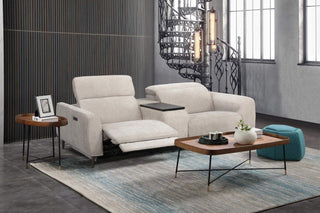 Modern living room with a beige sofa, coffee table, and decorative items.