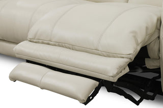 Beige leather recliner sofa with footrest on a white background