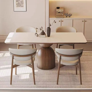 Dining room with a modern table and chairs in a well-lit room.