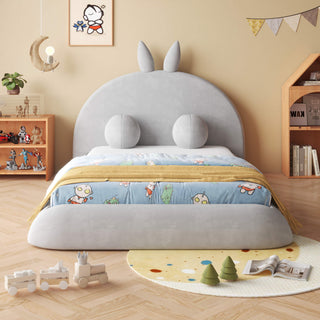 Children's room with a bed featuring a cartoon character headboard, toys, and books.
