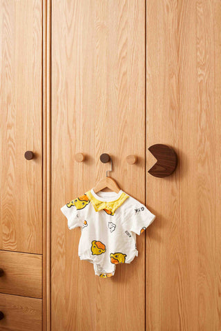 Baby onesie with cartoon design on a wooden wardrobe