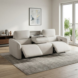 Beige 3 seater sofa in a modern living room with a rug and window.
