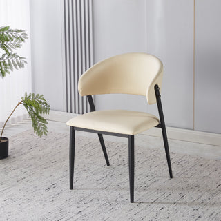 Beige chair with black legs in a room with a plant and radiator.