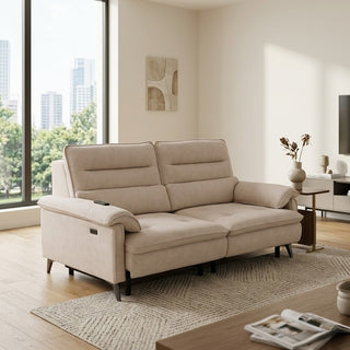 Beige extendable couch in a modern living room with large windows and decor.