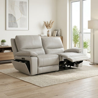 Beige recliner sofa in a modern living room with large windows.