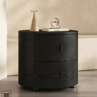 Black bedside table with decorative items on a neutral background