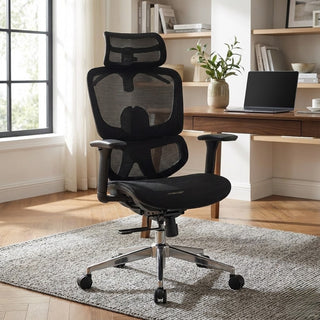 Black mesh office chair in a home office setting with a desk and laptop.