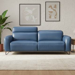 Blue leather sofa in a living room setting with abstract art on the wall.