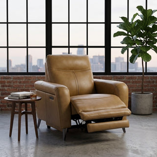 Brown leather electric recliner armchair in a room with large windows and a plant.