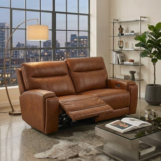 Brown leather recliner sofa in a living room with a cityscape view through large windows.