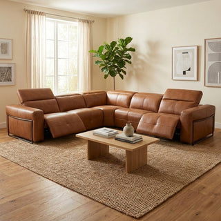 Brown leather sectional sofa in a living room with a coffee table and decorative items.