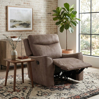 Brown recliner chair in a cozy living room with a plant and side table.