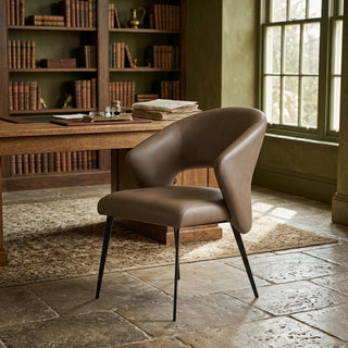 Brown restaurant chair in a room with a wooden desk and bookshelves.