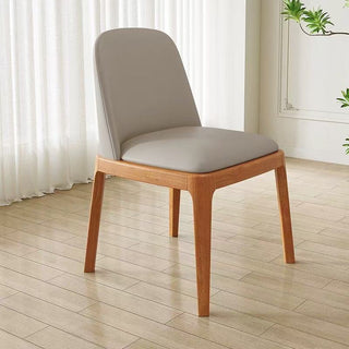 Chair with wooden frame and gray cushion on a wooden floor