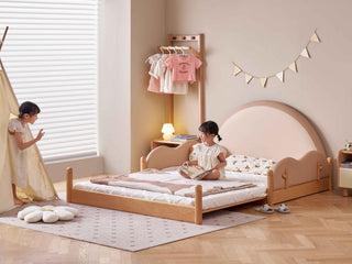 Children's bedroom with a wooden bed, clothes rack, and toys.