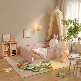 Children's bedroom with pink bed, toys, and decor elements.