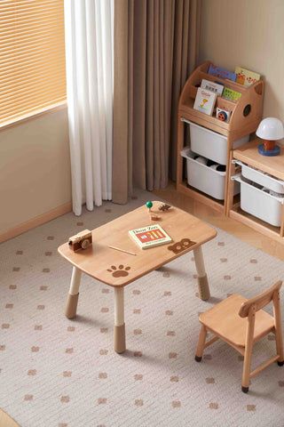 Children's play area with a wooden table and chair on a patterned carpet.