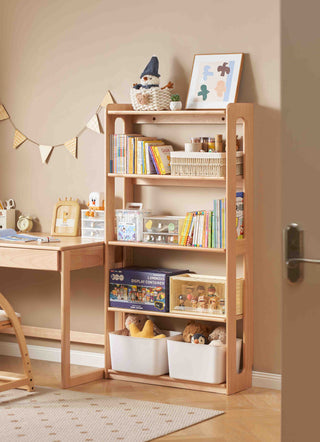 Children's room with wooden desk and bookshelf filled with toys and books.