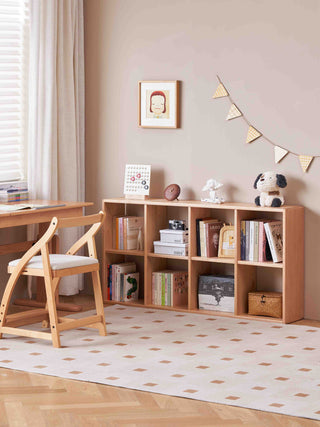 Children's room with wooden desk, chair, and bookshelf.