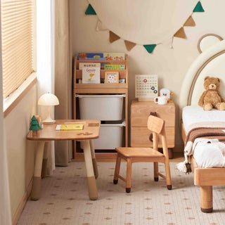 Children's room with wooden furniture, books, and a teddy bear.