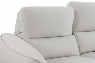 Close-up of a light gray sofa with a neutral background