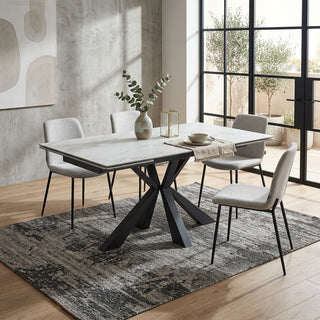 Dining room with 8 seater extending dining table on a textured rug.