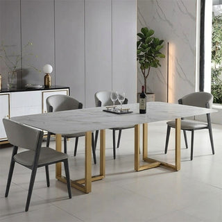 Dining room with a marble table and chairs in a modern interior setting.