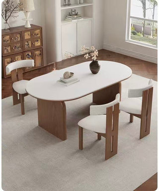 Dining room with a modern table and chairs on a gray rug.