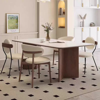 Dining room with a wooden table and chairs on a patterned floor.