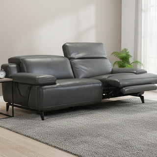 Gray leather recliner sofa in a living room setting with a neutral color palette.