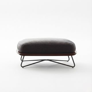 Gray ottoman with a black metal base on a white background