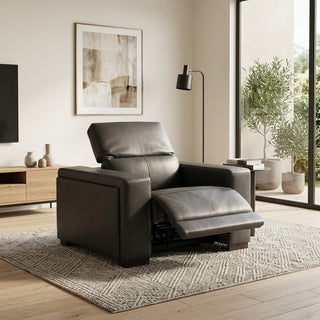 Gray recliner chair in a modern living room with a rug, TV, and decor.