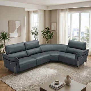 Gray sectional sofa in a living room with plants and a coffee table.