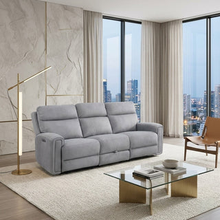 Grey sofa in a modern living room with large windows and cityscape view.