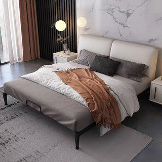 Modern bedroom with a bed, nightstands, and decorative elements.