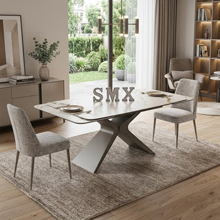 Modern ceramic extending dining table with chairs and decorative elements.
