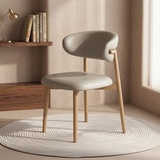 Modern dining chair with wooden legs in a room with a shelf and books.
