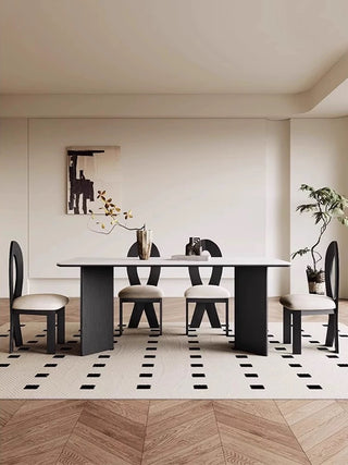Modern dining room with a black and white checkered floor, white walls, and a black dining table with chairs.