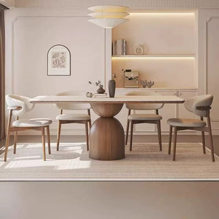 Modern dining room with a stylish table and chairs in a well-lit room.