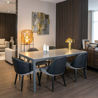 Modern dining room with a table and chairs, decorative lamps, and wall art.