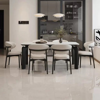 Modern dining room with a white table and chairs in a stylish interior.