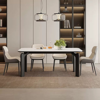 Modern dining room with a white table and chairs in a stylish interior setting.
