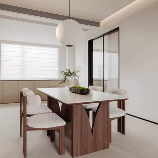 Modern dining room with wooden table and chairs in a minimalistic setting