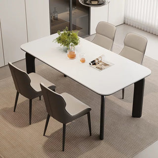 Modern dining table with chairs in a minimalistic room.
