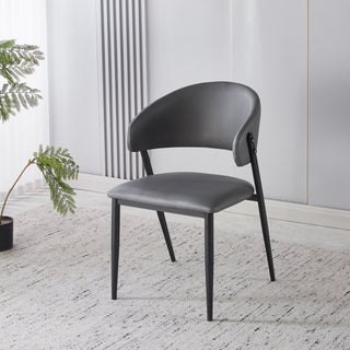 Modern gray chair in a minimalistic room with a plant and radiator.